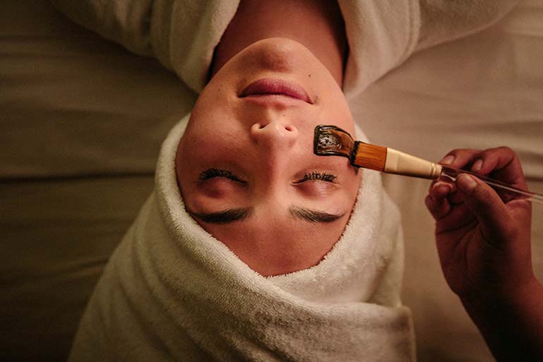 A woman getting a facial at a high end resort.